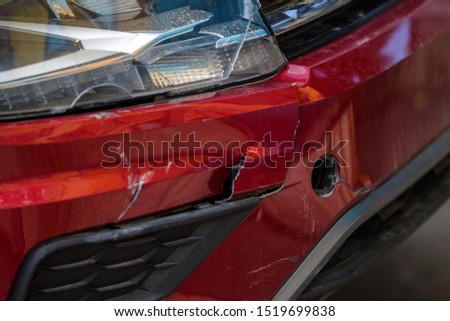 The body of the car is damaged as a result of an accident. High speed head on a car  traffic accident. Dents on the car body after a collision on the highway