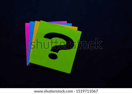 Question mark on sticky notes isolated on black background