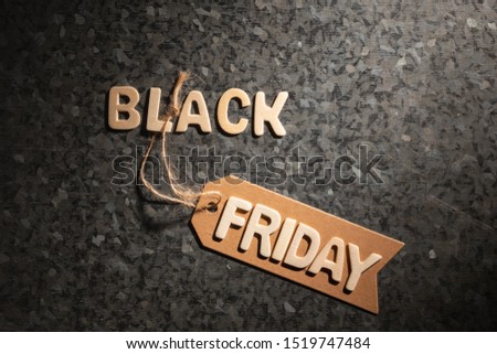 Black friday wooden letters on a zinc finish background
