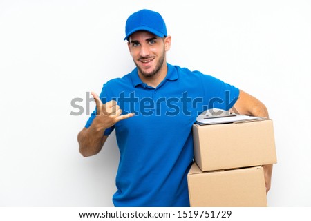 Delivery man over isolated white background making phone gesture