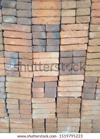 photo of a pile of red bricks in front of the house