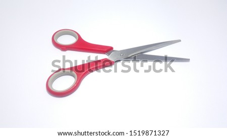 Red scissors on a white background.