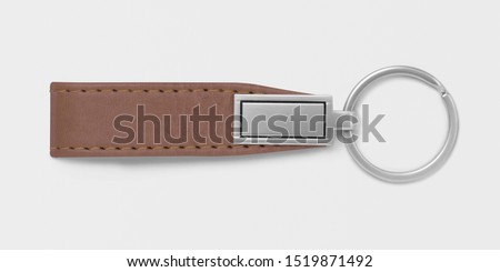 Beautiful leather keychain with sliver key ring and logo placeholder on isolated background.