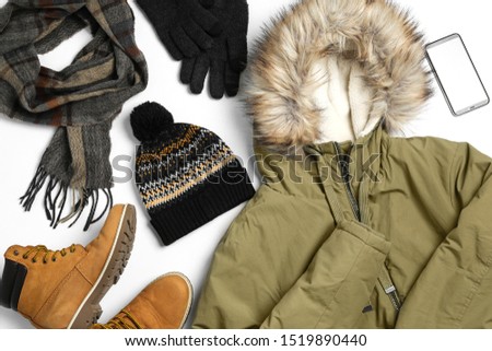 Set of stylish winter clothes on white background, top view