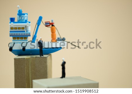 Miniature people: Business people standing on paper box with Thai fishing ship. concept of cargo shipping and import export