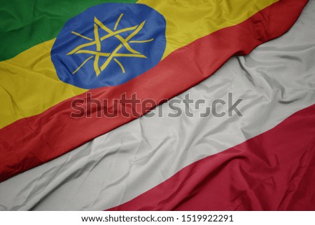 waving colorful flag of poland and national flag of ethiopia . macro