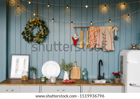 Kitchen, decorated for Christmas and New Year in white and blue shades of Scandinavian style Royalty-Free Stock Photo #1519936796