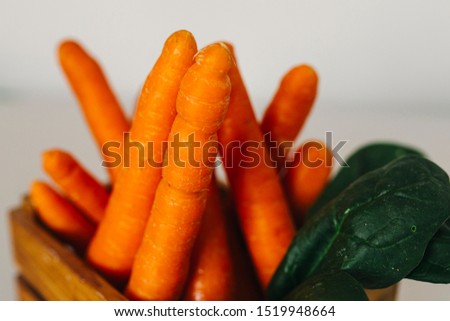 Carrots in wooden crate with white background
