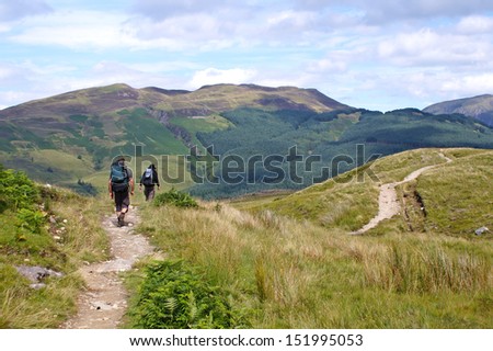 The back of some hikers along The West Highland Way through beautiful nature Royalty-Free Stock Photo #151995053