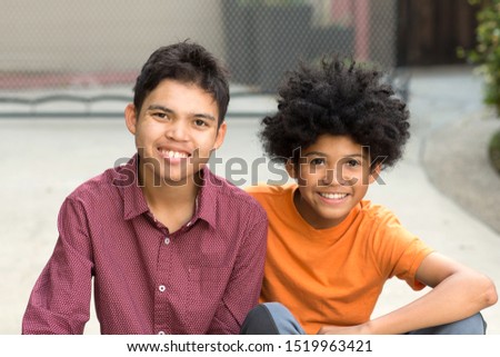 Portrait of two brothers outside. Royalty-Free Stock Photo #1519963421