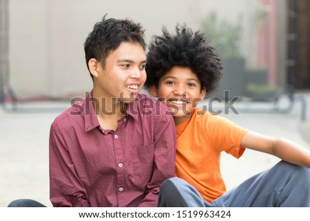 Portrait of two brothers outside. Royalty-Free Stock Photo #1519963424