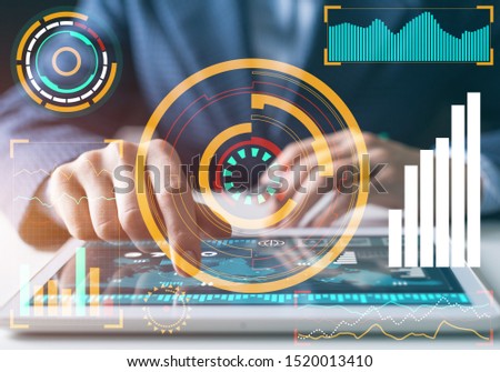 Modern computing in business analytics. Businessman hand touching virtual screen. Online project management and business intelligence. Statistic diagrams visualization and financial growth concept