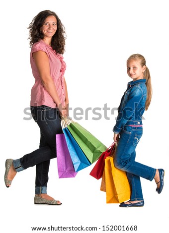 Smiling mother and daughter with shopping bags on a white background