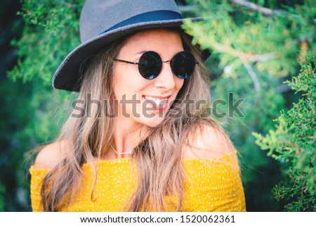 portrait of smiling young woman wearing hat