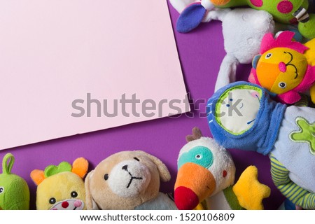 Colorful kids toys frame on wooden background. Top view. Flat lay. Copy space for text