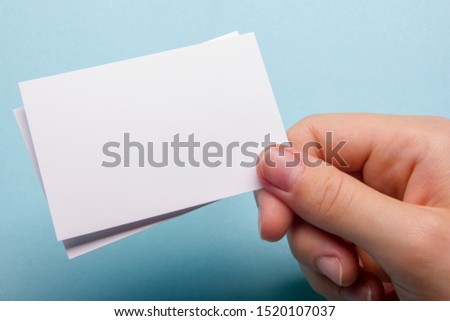 Hand holding business card blank on abstract background