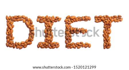 Inscription Diet of the English alphabet from a peeled  almond on a white isolated background.  Peeled  almond pattern.  healthy food concept. Sign from a photo of real nuts