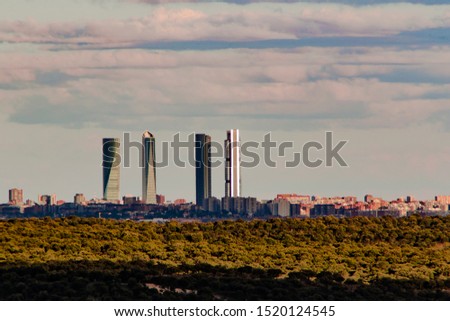 View of the four towers of Madrid. Four Towers Business Area is a business park next to the Paseo de la Castellana Madrid.In the foreground we can see the brown mountains