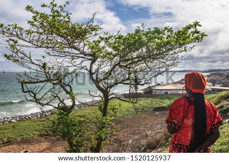 Africa Woman from Ghana looks out over Takoradi, located in West Africa Ghana.