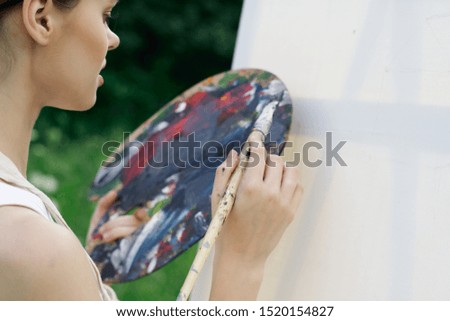 beautiful woman with paints for painting in hand artist brush