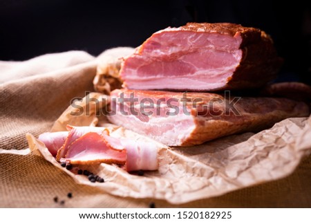 Smoked, traditional pork cold cuts. Smoked bacon in pieces and cut in slices.