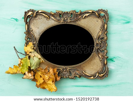 Baroque golden picture frame and autumn leaves
