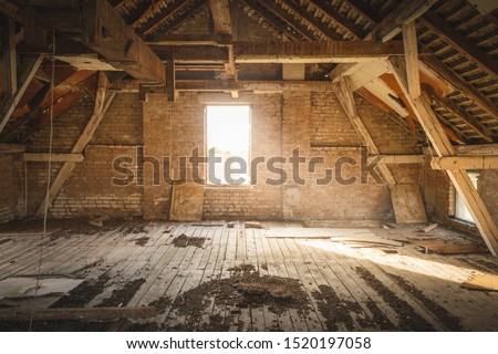 Old Rustic Attic with Sunlight coming through Window. Royalty-Free Stock Photo #1520197058