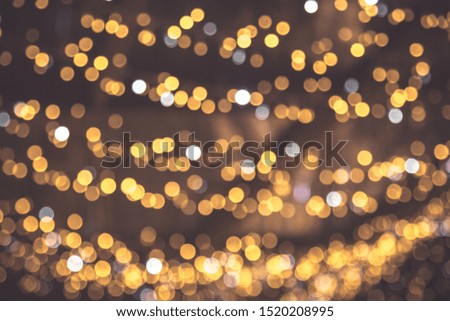 Gold abstract bokeh background. Christmas gold background. Golden holiday glowing backdrop.