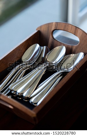Silver spoons in a Wooden container