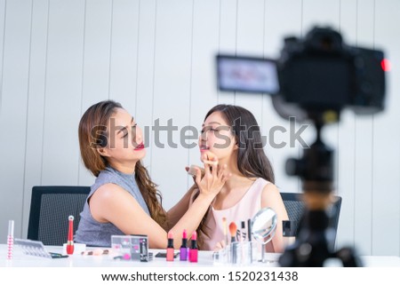 Young woman vlogger showing makeup tutorial online in internet. Wireless connection.