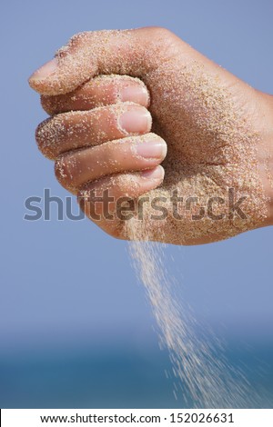 sand running through hands as a symbol for time running, lost 