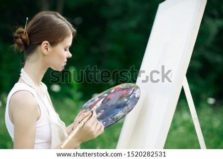 young beautiful woman with paint palette for painting