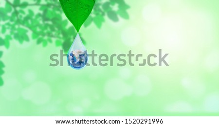 Ecology Concept : Planet earth globe in water drop with green natural in background. (Elements of this image furnished by NASA.)