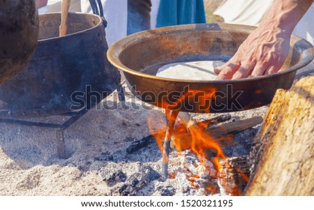 village festival. food is cooked on an open fire. hand making vintage cooking concept