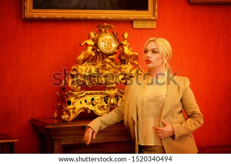 Portrait of a beautiful woman posing by clock