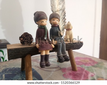 puppet couple seating on wooden table