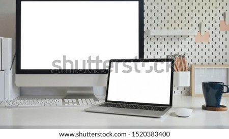 Laptop and Computer isolated white screen on workspace table.