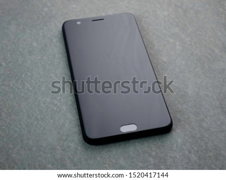 Smartphone on table, Isolated on grey background.