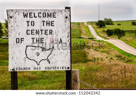 Wooden sign welcoming visitors to the geographical center of the continental United States near Lebanon, Kansas.