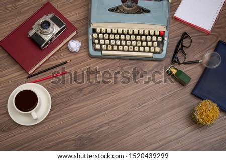 Typewriter on the old wooden desk with coffee cup