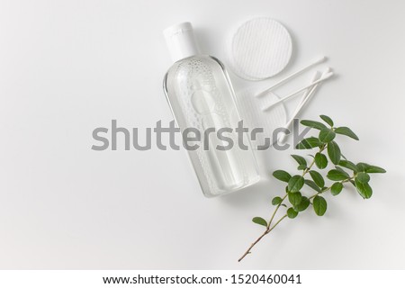 Micellar cleansing water, cotton buds and discs to remove cosmetics and cleanse the skin on gray. Copy space text Royalty-Free Stock Photo #1520460041