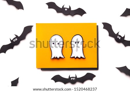 Halloween paper background with ghosts and flying bats on white