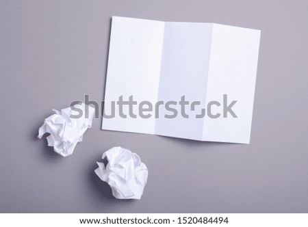 Empty flyer sheets, crumpled paper on grey background, top view. Mockup for design