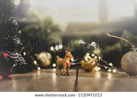 Christmas and New years holiday background with Reindeer ,tree branches ,golden ball and Christmas decoration on wooden vintage table.