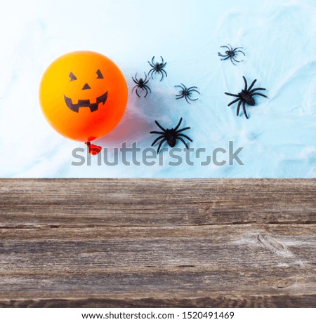 Empty table with halloween scene with balloons border on blue background