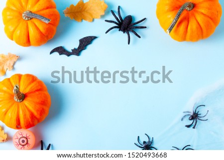 Orange halloween pumpkins on blue background flat lay frame with copy space
