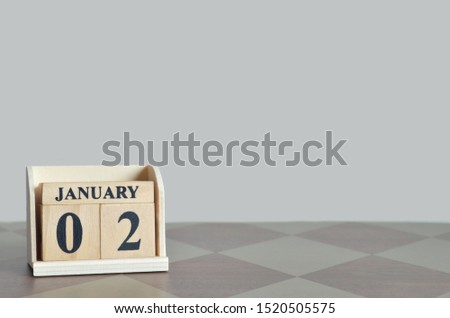 January 2, Empty gray Background with number cube on the table.