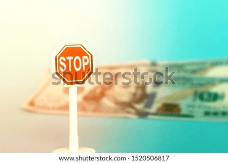Stop sign on a background of american dollars. Concept - ban on the circulation of the dollar.