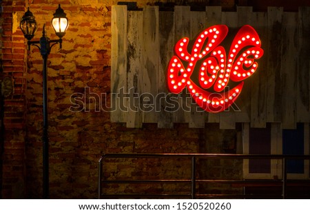 Vintage style orange wall background photos There are light poles and lamps and the red l o v e logo. Warm Light is a beautiful picture basket