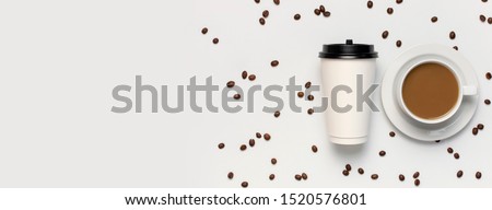 Coffee or tea paper cup, white cup with coffee, coffee beans on light gray background top view flat lay copy space. Take away coffee cup, mockup. Minimal composition, layout for design